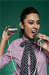 Businesswoman using a tin can phone