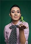 Businesswoman holding a seedling