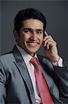 Businessman talking on a mobile phone and smiling