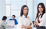 Portrait of two businesswomen with arms crossed