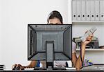 Businesswoman working on a desktop PC in an office