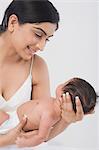 Woman carrying her baby and smiling