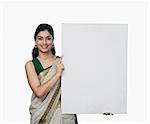 Portrait of a woman holding a whiteboard and smiling