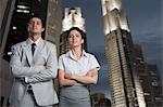 Business couple standing in a city