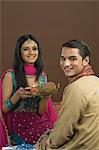 Woman doing aarti of her brother at the festival of Rakhi