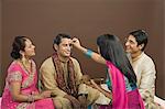 Woman applying tilak on her brother's forehead at Raksha Bandhan festival
