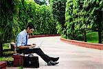 Businessman using a laptop in a park