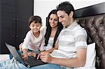 Man doing online shopping with his family