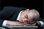 Businessman sleeping on a laptop