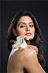 Portrait of a woman holding a Tiger Lily flower