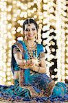 Woman celebrating Diwali festival with a sparkler