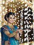 Woman celebrating Diwali festival with a sparkler