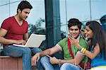 University students listening to music on a mobile phone