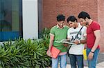 University students reading a book in university campus