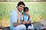 Farmer and his daughter in the field, Sohna, Haryana, India