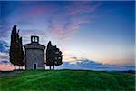 Chapel of Vitaleta with Cypress Trees at dusk after sunset. Chapel of Vitaleta, Val d'Orcia, Siena Province, Tuscany, Italy.