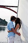 Croatia, Young couple on sailboat kissing, side view