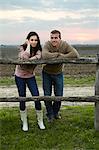 Young Couple Leaning On Wooden Fence, Baranja, Croatia, Europe