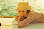 Croatia, Adriatic Sea, Young woman on sailboat at sunset, musing