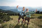 Germany, Bavaria, Two boys in traditional clothing fooling around in mountains