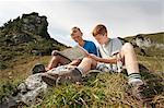 Germany, Bavaria, Two boys in mountains reading a map