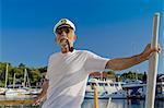 Croatia, Senior man with captain's hat on sailboat