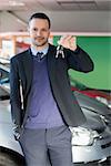 Man holding car keys in a garage