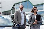 Man buying a new car in a garage