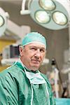 Close up of a surgeon looking at camera in an operating theatre