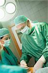 Surgeon holding a scalpel in a surgical room