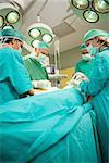 Medical team operating a patient in a surgical room