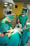 Surgeon and his team working on a patient in a surgical room