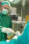 Surgeon holding scalpel during an operation in a surgical room