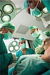 Medical team working on a bleeding patient in a surgical room