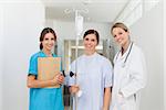 Doctor standing in a hallway with a patient and a nurse in a hospital