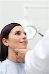 Woman patient being auscultated by a doctor in an examination