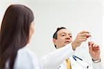 Doctor checking an injection for a patient in an examination room