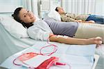 Smiling transfused patient next to another in hospital ward