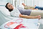 Transfused patients looking at camera in hospital ward