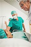 Doctor looking at a female patient in hospital corridor