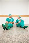Surgeons sitting on the floor in a hospital