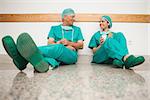 Surgeons talking while sitting in the floor in hospital
