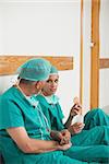 Surgeons eating biscuits in hospital hallway