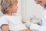 Doctor giving to a child an injection in examination room