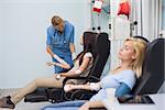 Nurse looking after a blood donor in hospital ward