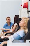 Blood donor with closed eyes in hospital ward