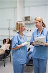 Nurses talking and smiling in hospital ward