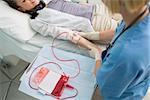 Nurse taking care of a transfused patient in hospital ward