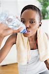 Close up of a black woman drinking in a living room