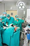 Nurse adjusting a monitor in an operating theatre